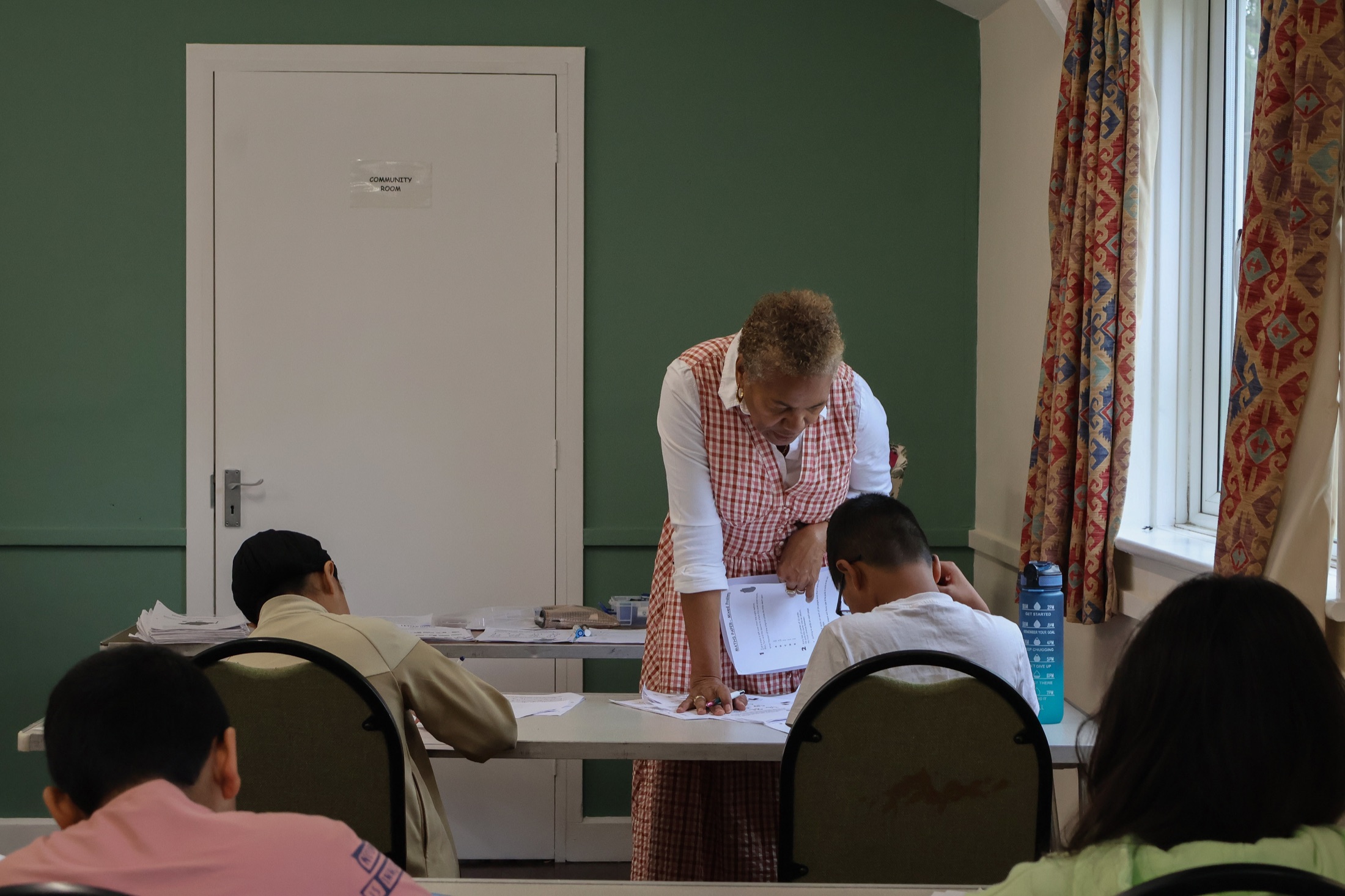 Maxine helping children with their classwork