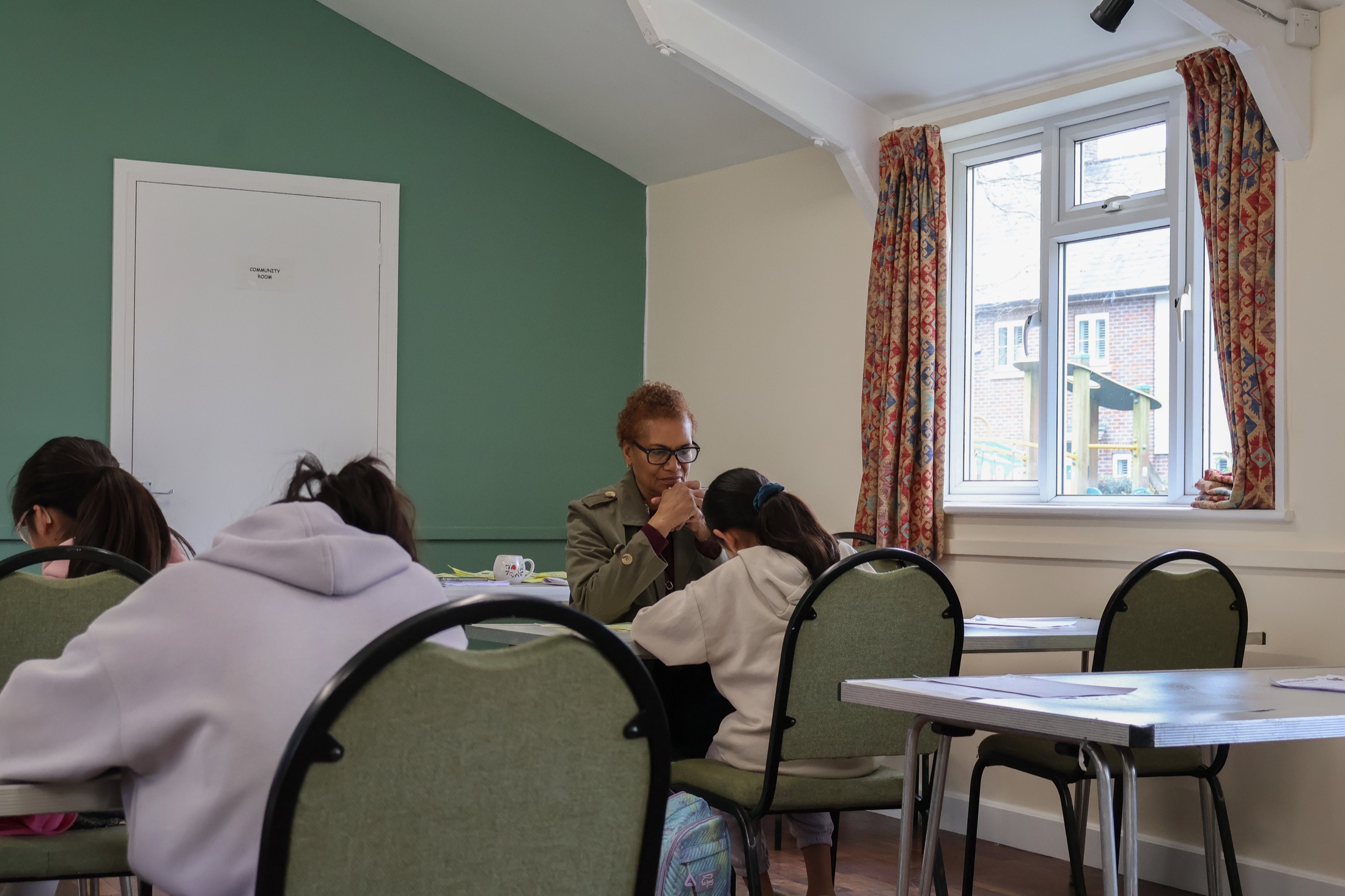 Maxine offering one-to-one support during a lesson