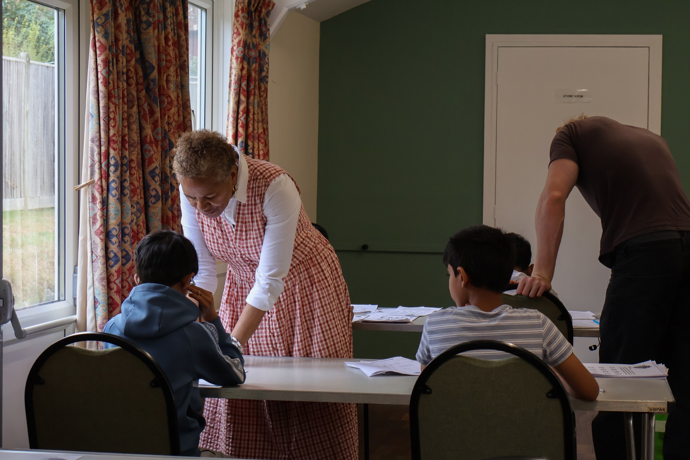 Maxine supporting pupils during a small-group class