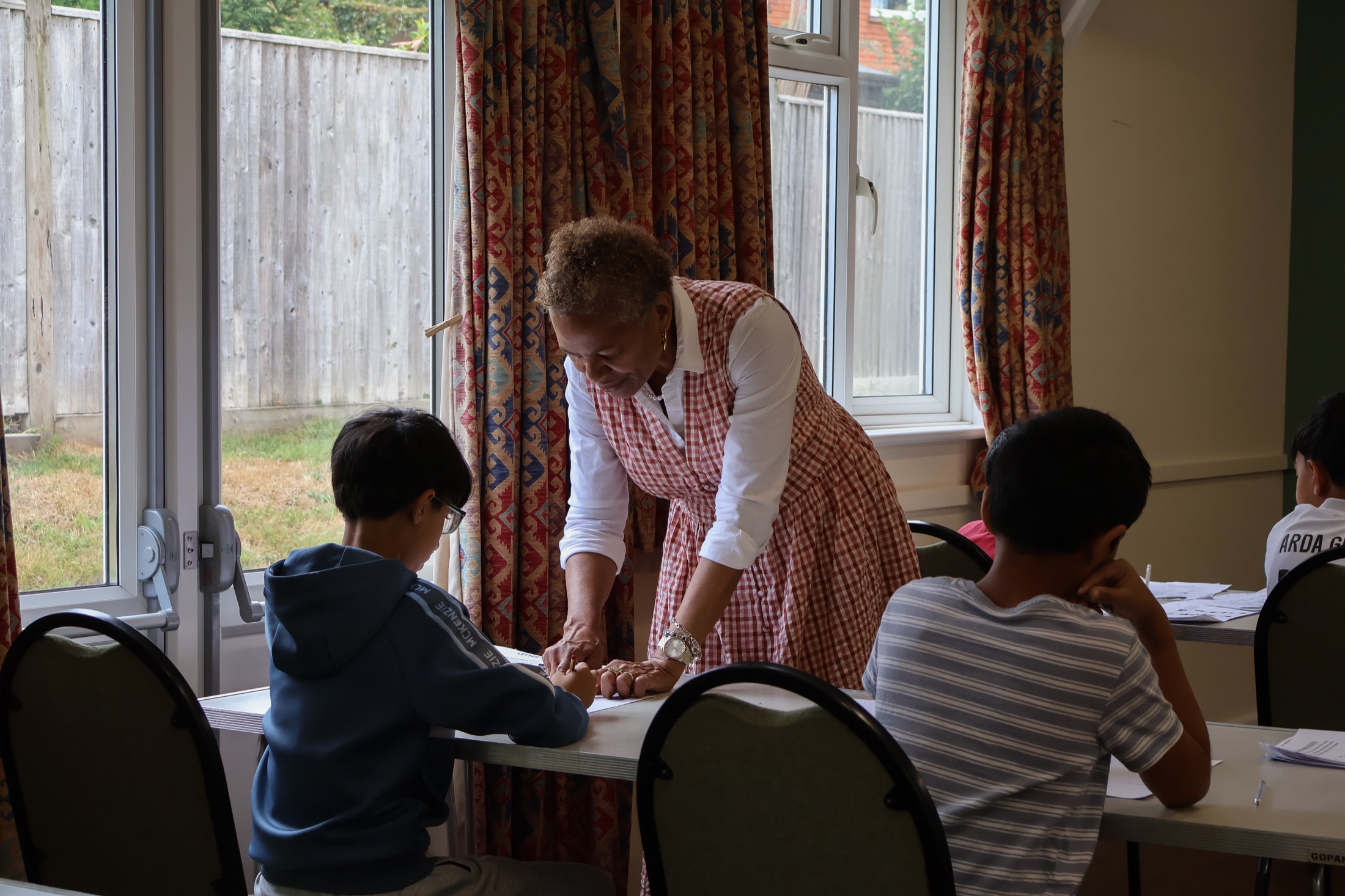 Maxine giving one-to-one guidance during a workshop